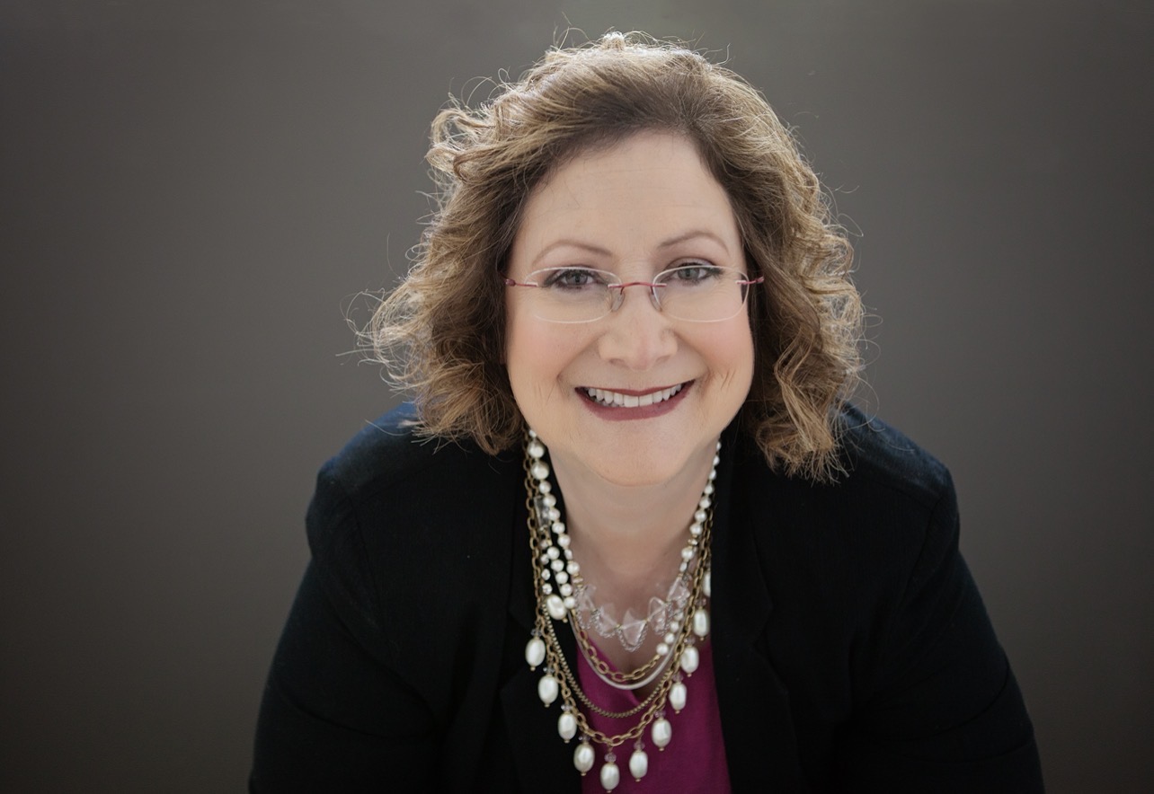 Barbara Harrington wearing a black blazer and layered pearl necklaces